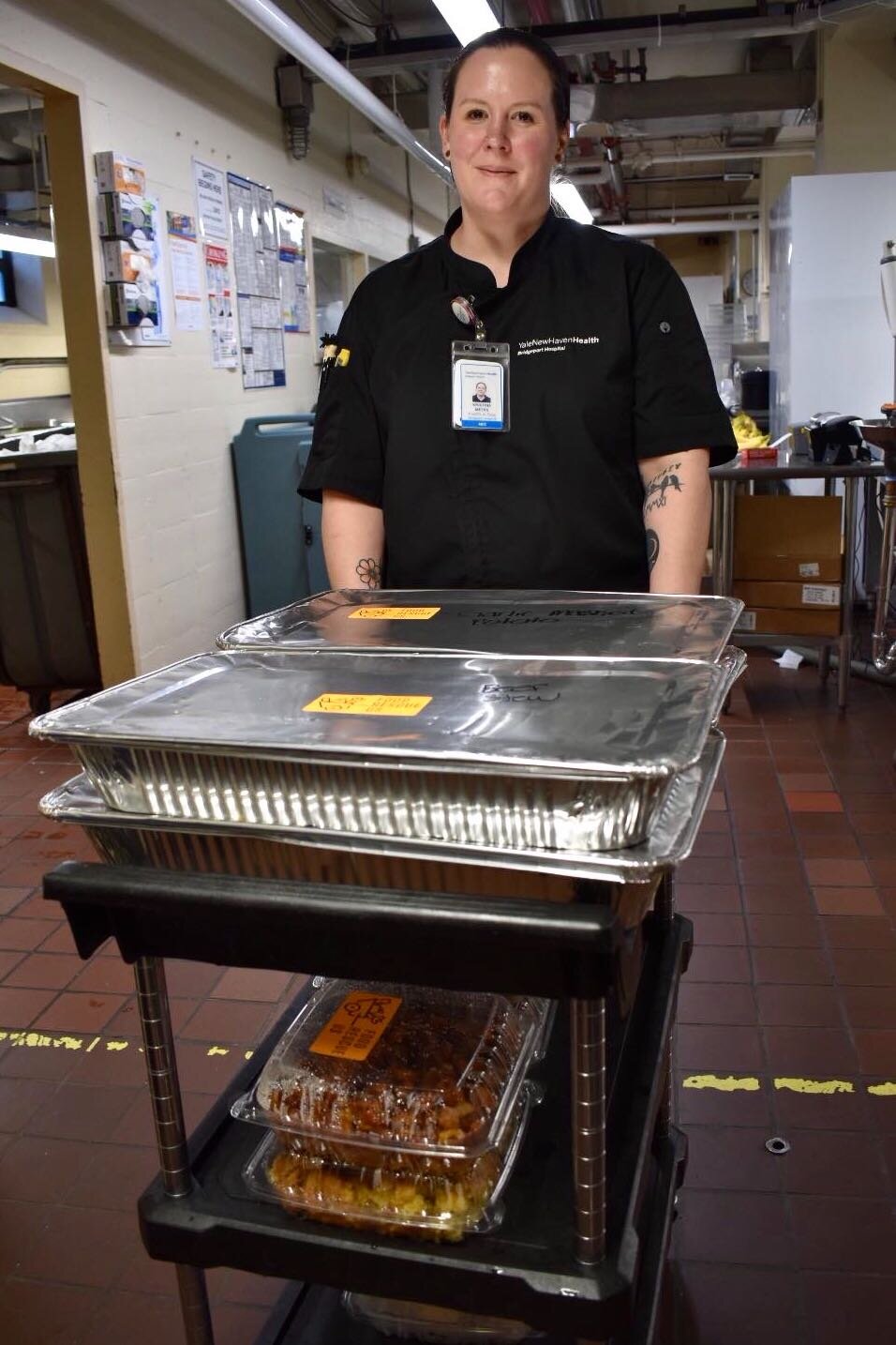 Sam Conti, a Bridgeport hospital dining employee, prepares to take trays of leftover food to be donated.