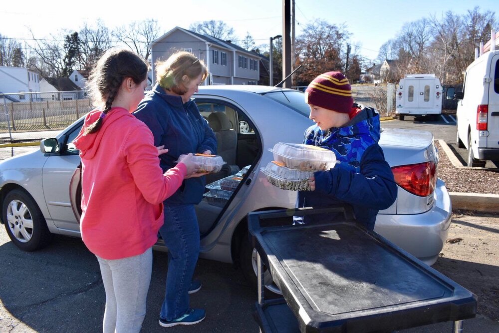 Jodi Franchi of Milford and her two grandchildren aid the effort of Haven Harvest to provide food for those facing food insecurity. Franchi and her grandchildren are picking up food that will be distributed to those in need.