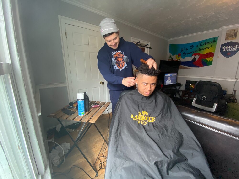 Senior Kevin Fuller getting his haircut in the comfort of his Hamden home. Photo Credit: John Morgan