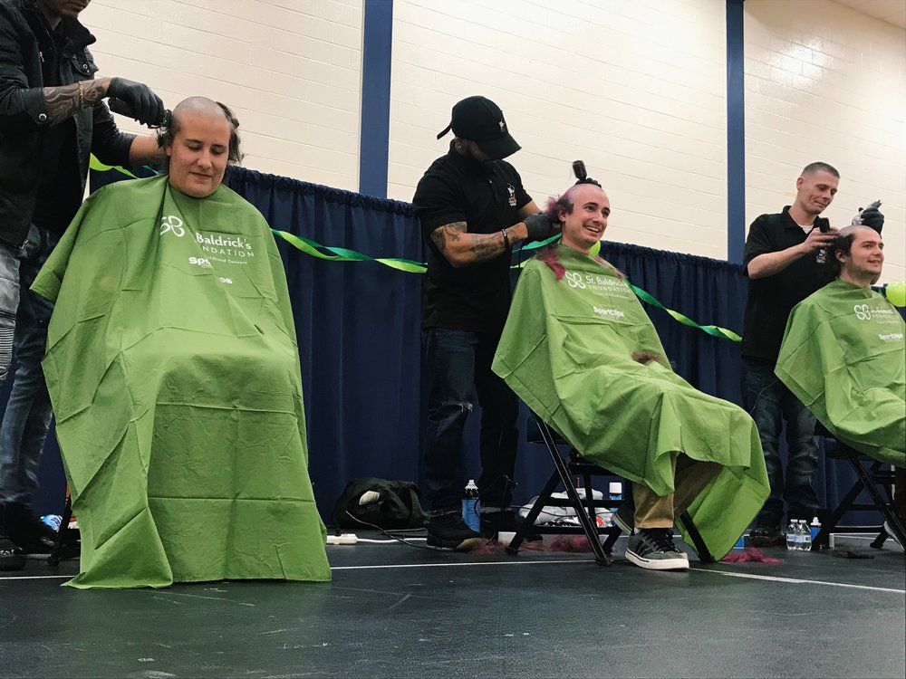 Three shavees lose their locks at Monday night’s event.