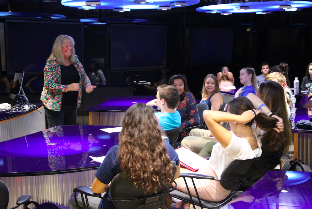 Professor Terri Corigliano teaches her public speaking course with a wide smile across her face.