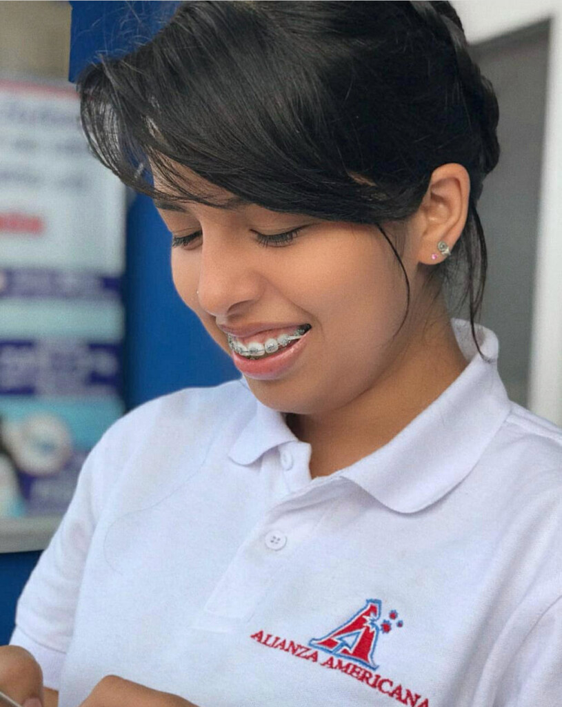 Anyoleth Rizo Gutierrez, nicknamed Any, smiling during work at Alianza Americana teaching English classes. Photo courtesy of her friend, Sonia Belén Lopez.