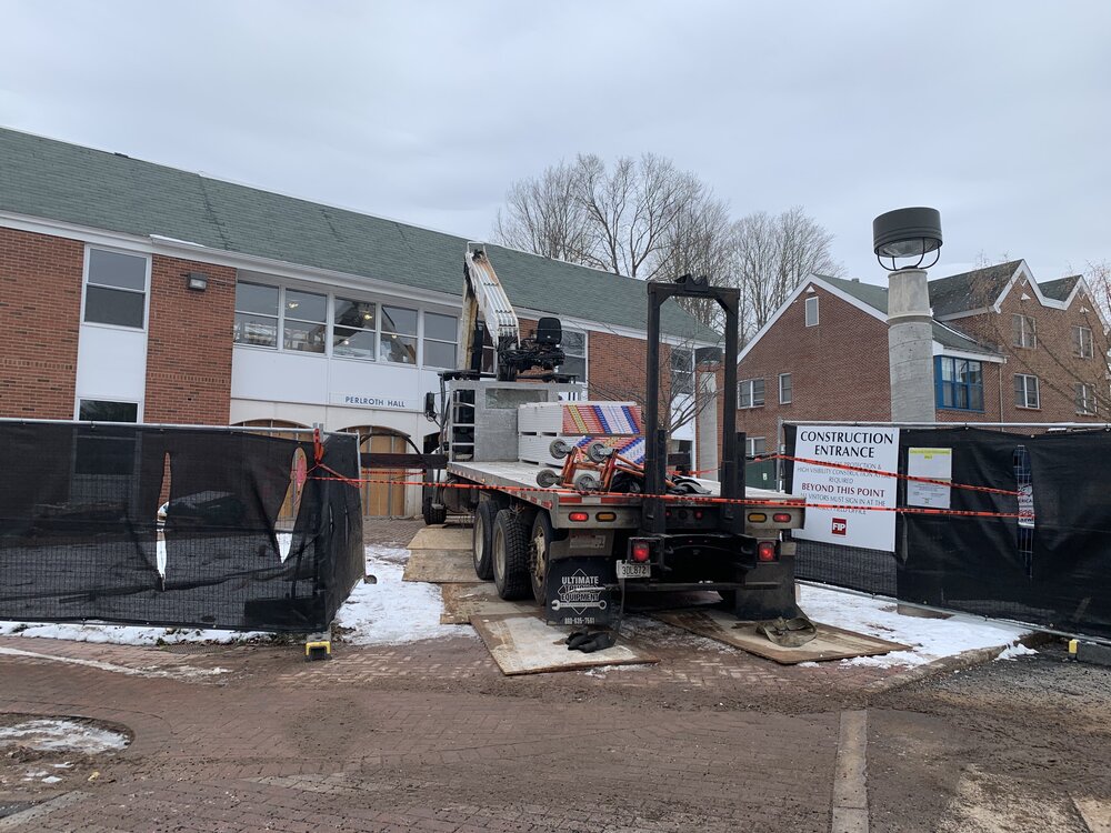 Construction vehicle in front of Perlroth residence hall.