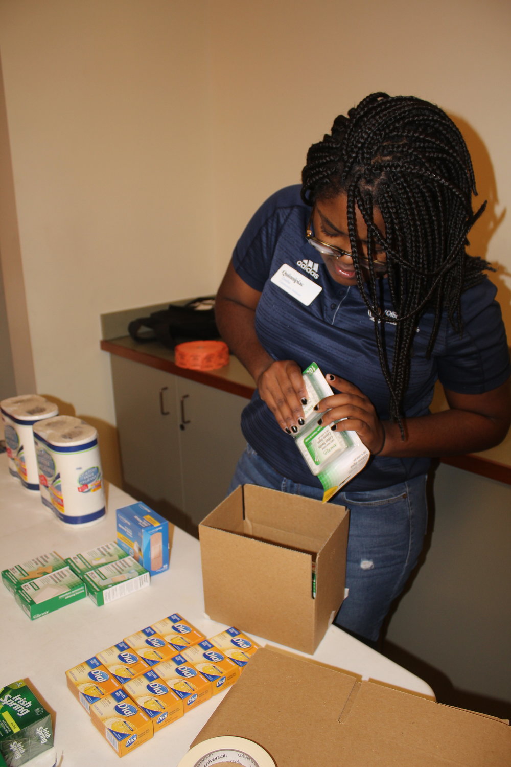 Community Assistant Cynthia Clements making a care package for Homes for the Brave