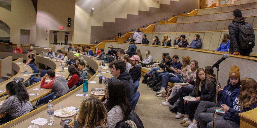 The crowd at the event, consisting of more than just students. Free pizza was provided by Quinnipiac University, as well as a raffle.