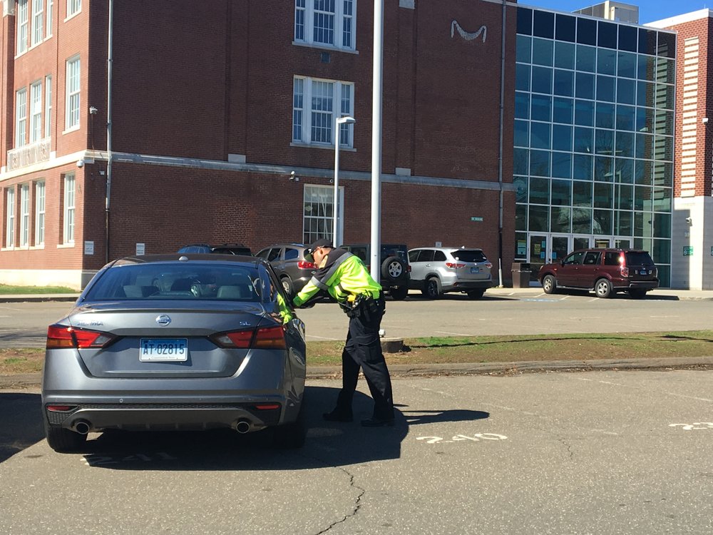 A Hamden PD officer speaks with an individual in violation of distracted driving.  (Photo: Sam Bashaw)