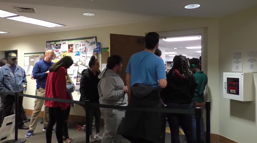 A picture at Hamden’s election day registration polling location with a line of people waiting.