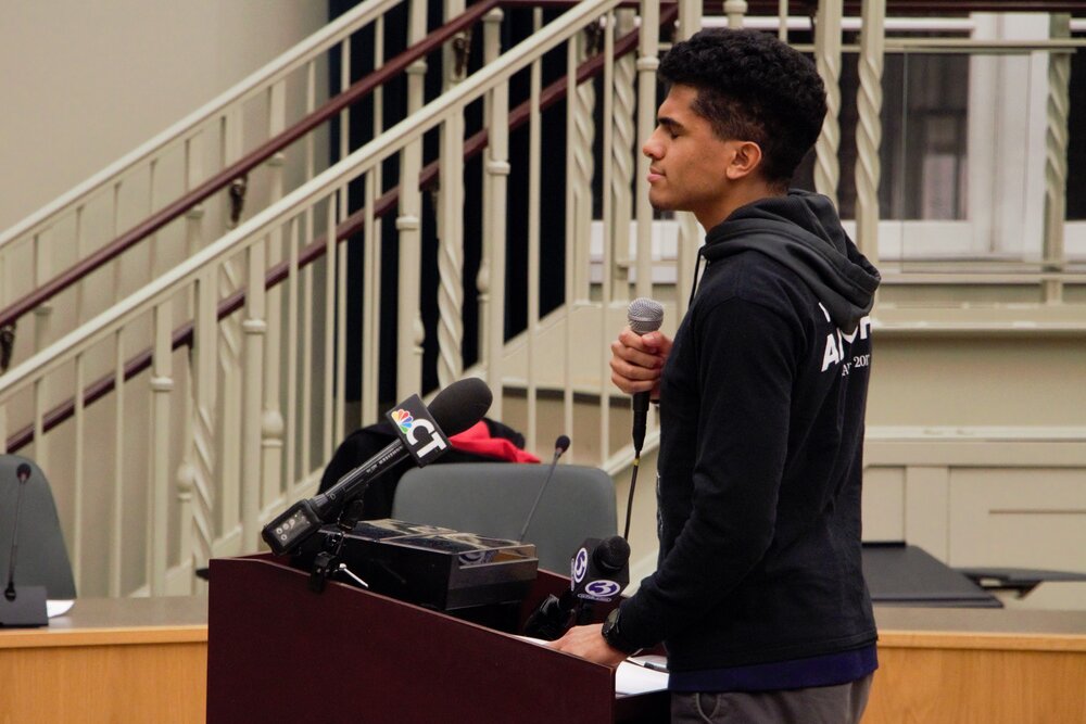 Ben Dormus taking a deep breath and collecting himself. He voiced his concerns with the way the Hamden Police Commission runs and how it is treating the protesters. The crowd clapped for Dormus because he didn’t back down when Iezzi interrupted him. Photo by Bryan Proctor.