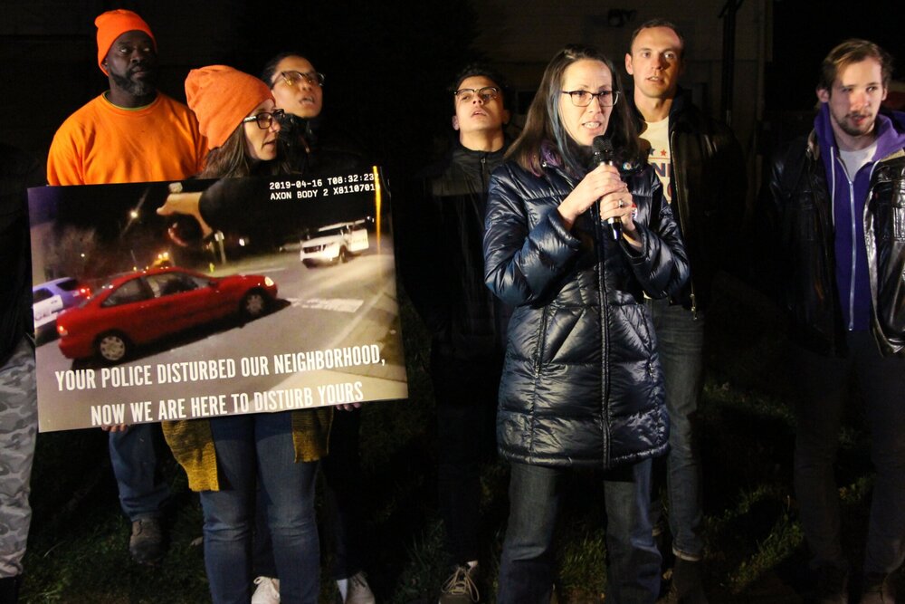 Laurie Sweet speaking in front of Leng’s house demanding justice for the police shooting that took place in April. Photo by Bryan Proctor.