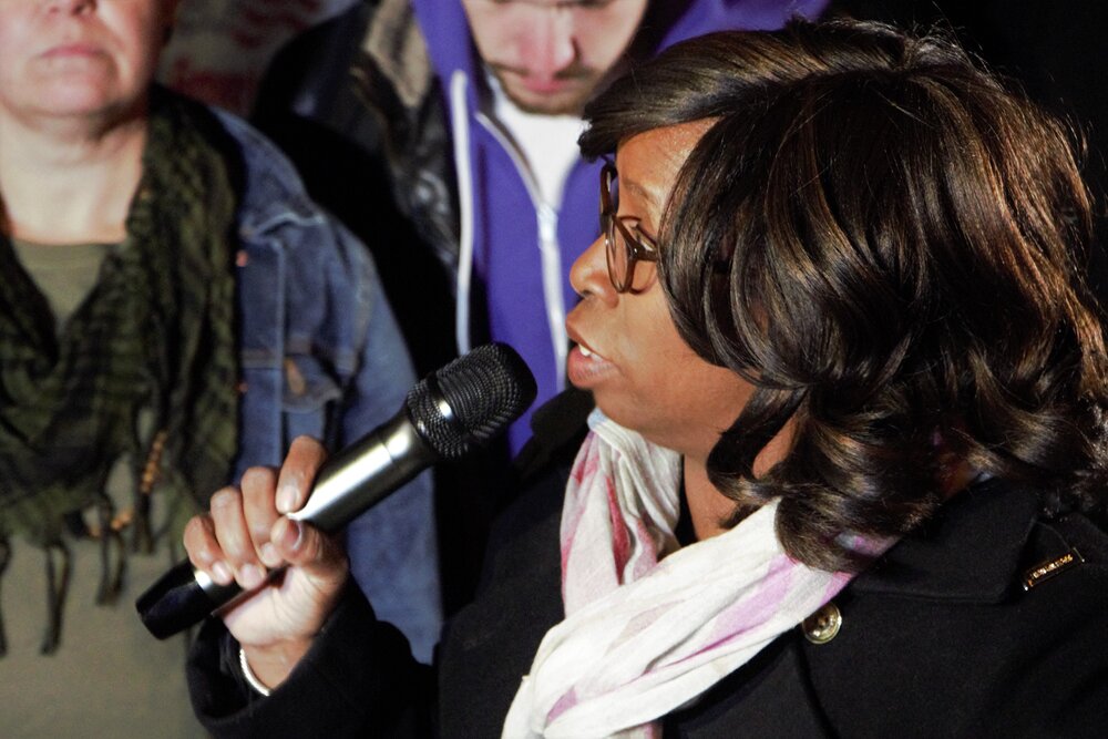 Rhonda Caldwell, organizer, speaking at the protest in front of Leng’s property. Photo by Bryan Proctor.