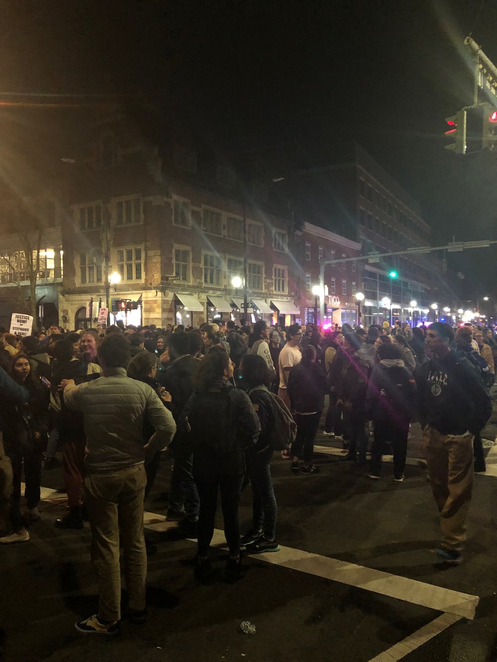 Yale students and New Haven residents stand at the intersection of College and Crown Street in New Haven.