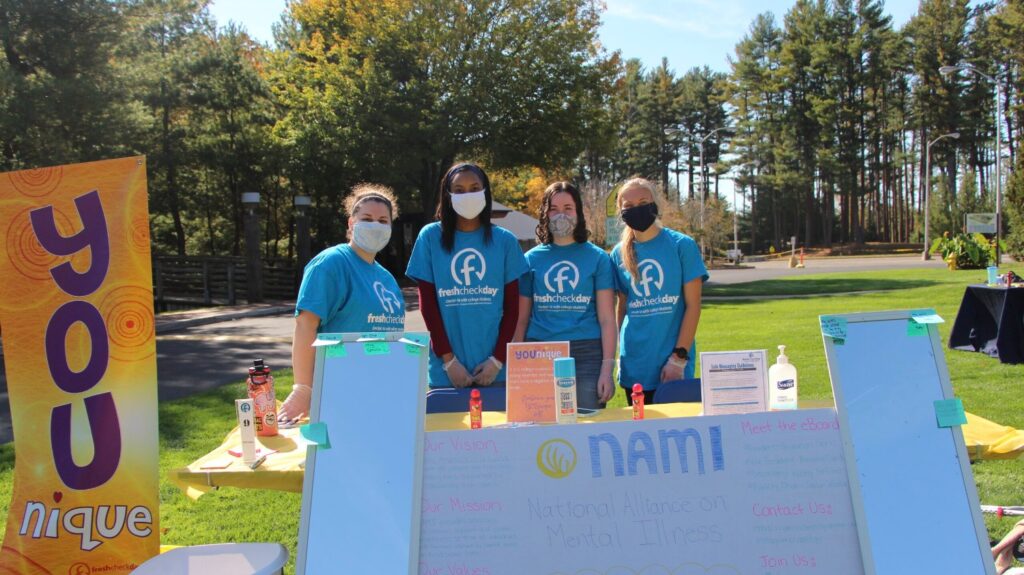 Student volunteers stand in front of the National Institute Of Mental Health 
 booth to promote the largest scientific organization which is dedicated to research focused on the understanding, treatment, and prevention of mental disorders and the promotion of mental health, especially during COVID-19.
(Photo by Marianna Rappa)