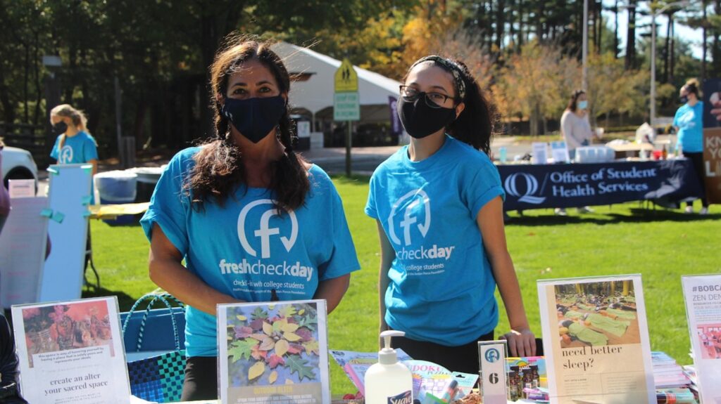 Tami Reilly, The director of fitness and well-being stands with a student volunteer at the Health and Wellness booth to promote wellness programs and activities. Programs run by the department help students cope with their mental health during COVID-19. (Photo by Marianna Rappa)