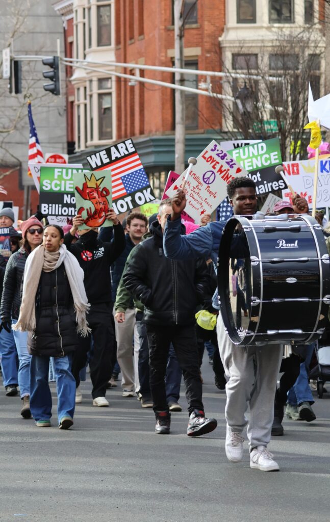 A steady rhythm drives the march as a drummer helps lead protesters through New Haven. Hannah Freshman/HQNN