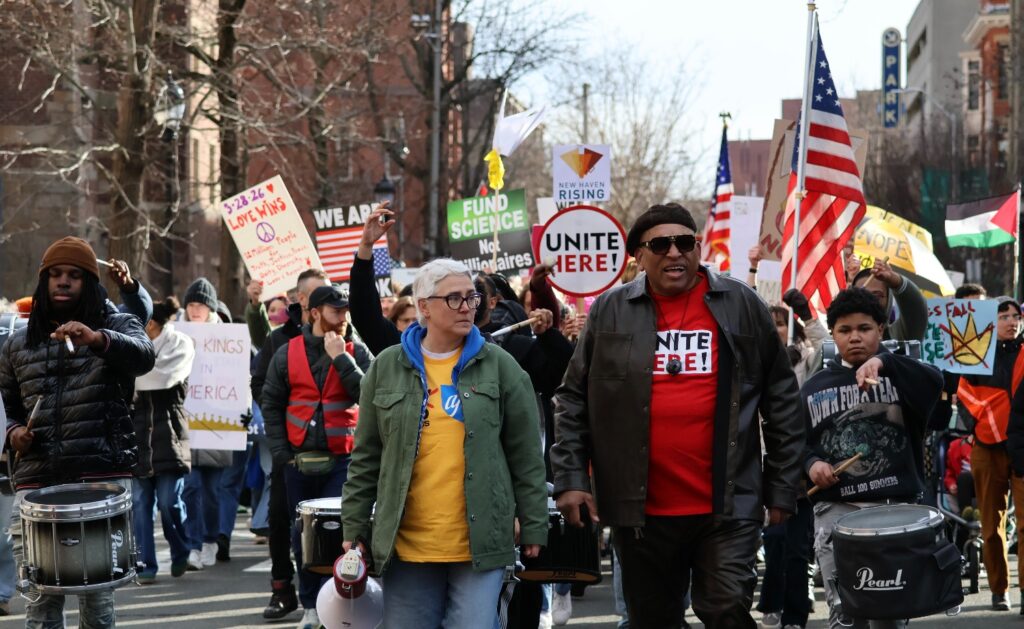 At the front of the march, Leslie Blatteau (left) and Rev. Scott Marks (right) help lead demonstrators through New Haven. Hannah Freshman/HQNN