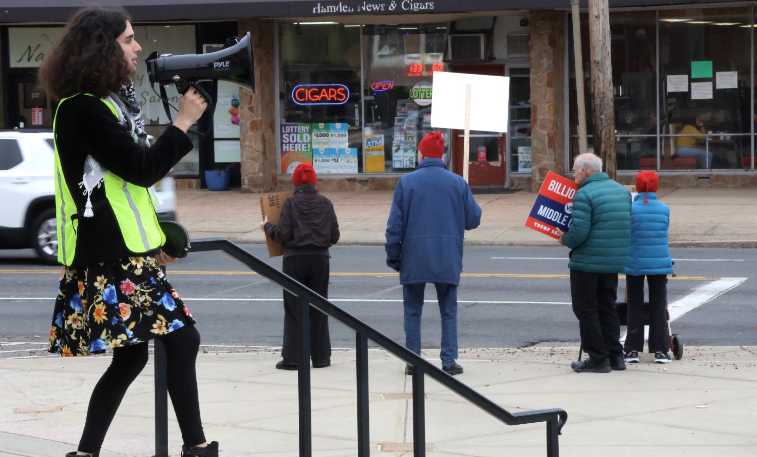 A protest marshal leads demonstrators in a chant of “healthcare, not warfare”. Hannah Freshman/HQNN