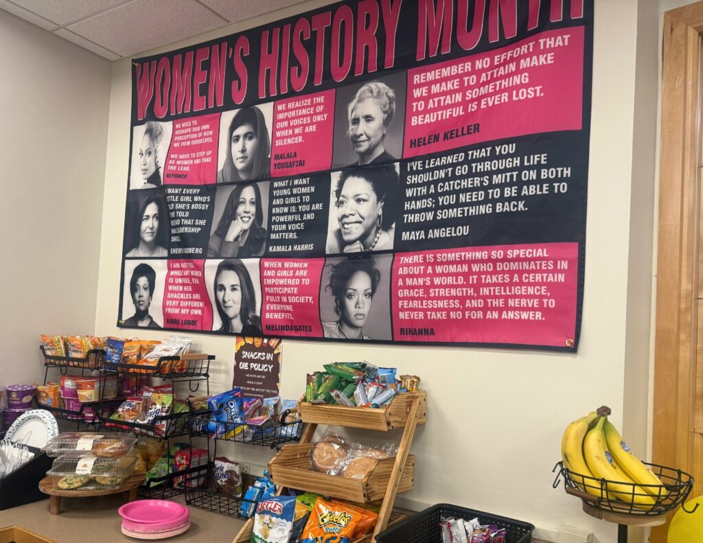 At the entrance of the Office of Inclusive Excellence, visitors find a spread of free snacks and a display celebrating Women’s History Month. Assistant director Briona Grant implemented the snack policy to draw students into the space, offering a casual environment to grab a bite to eat and chat while building a sense of community. Hannah Freshman/HQNN