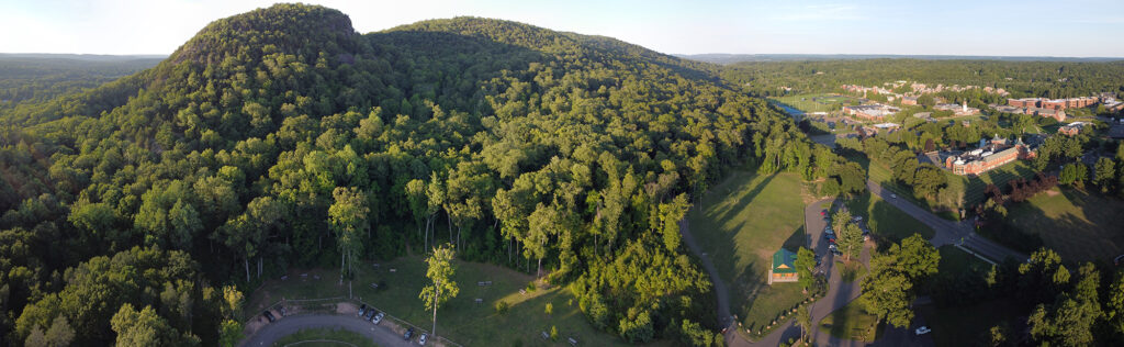 Wooded ridgelines separating trails from roads are seen next to Sleeping Giant, which itself is next to Quinnipiac University - all what Yale's professor of Population and Community Ecology Oswald Schmitz calls a "Woodburb."