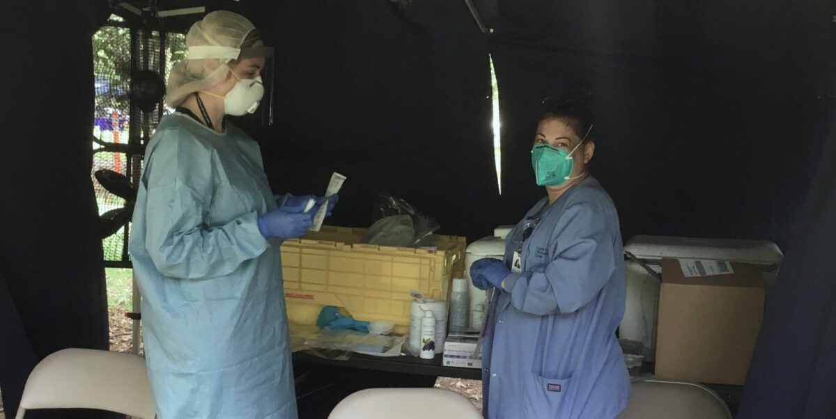 Nurses from Cornell Scott-Hill Health in New Haven set up a COVID-19 testing site for the public in Upper Green Park in New Haven on Monday, Aug. 31, 2020. The tests are free and information on the pop-up testing sites are available on Cornell Scott-Hill's website, cornellscott.org. (Photo by Jared Penna)