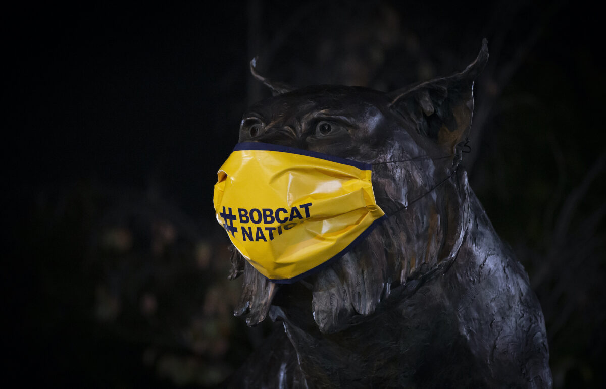 A statue on Bobcat Way wears a mask to encourage mask use at Quinnipiac University.