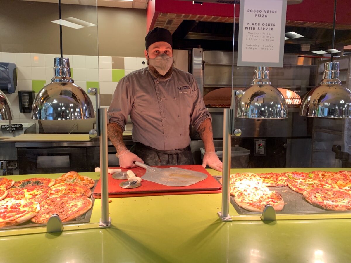 Joe Kasperzyk prepares pizza and other brick oven style food for Quinnipiac students and faculty throughout the day. Like all Quinnipiac staff and faculty, he wasn't required to receive a COVID-19 test before the semester started again, and won't need to receive tests throughout the fall like students will. (photo by Yanni Tragellis)