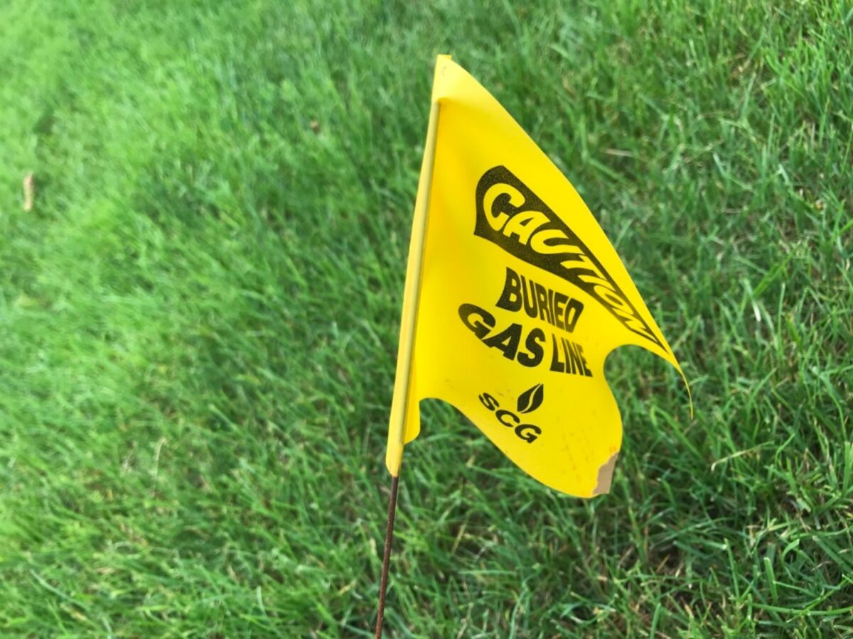 Flag designating the spot for a buried gas line. Found on Quinnipiac University's main campus near the Burt Kahn gymnasium. (photo by Stephen McLeod)