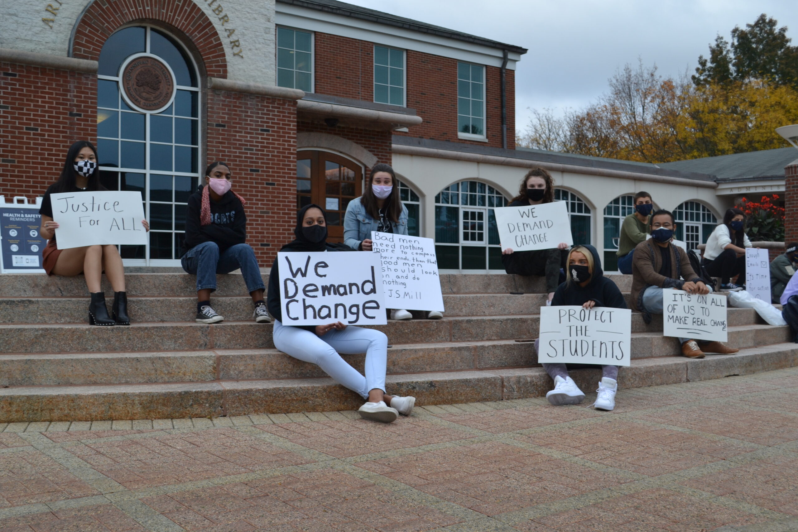 Quinnipiac students protesting on the library steps on the quad on Wednesday, Oct. 21. The protest lasted more than four hours, with multiple students subbing in and out if they had to go to class. (Photo by Owen Doody)