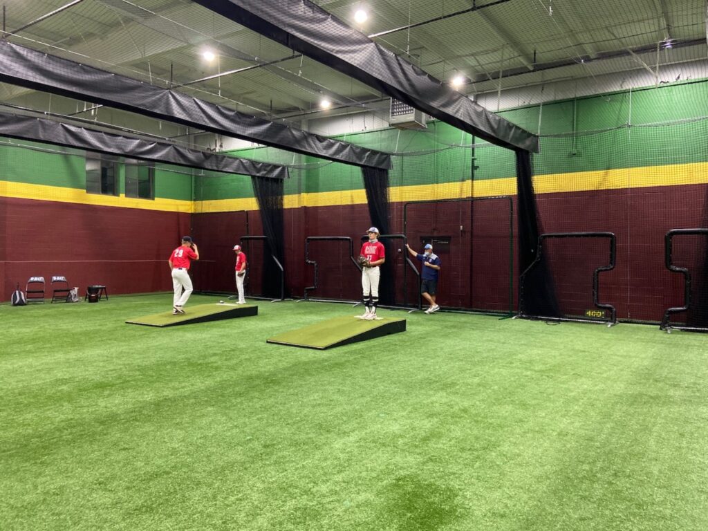 David Stimpson Jr. (right) pitches in front of scouts during a showcase at D-BATS in Cheshire on Sunday, Nov. 8. (Photo by David Rooney)