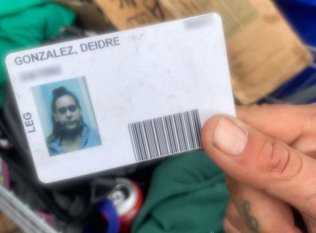 Deidre Gonzalez shares her shelter ID. For some homeless people, this may be the only ID that they have to access services. (Photo by Matt Nygaard)