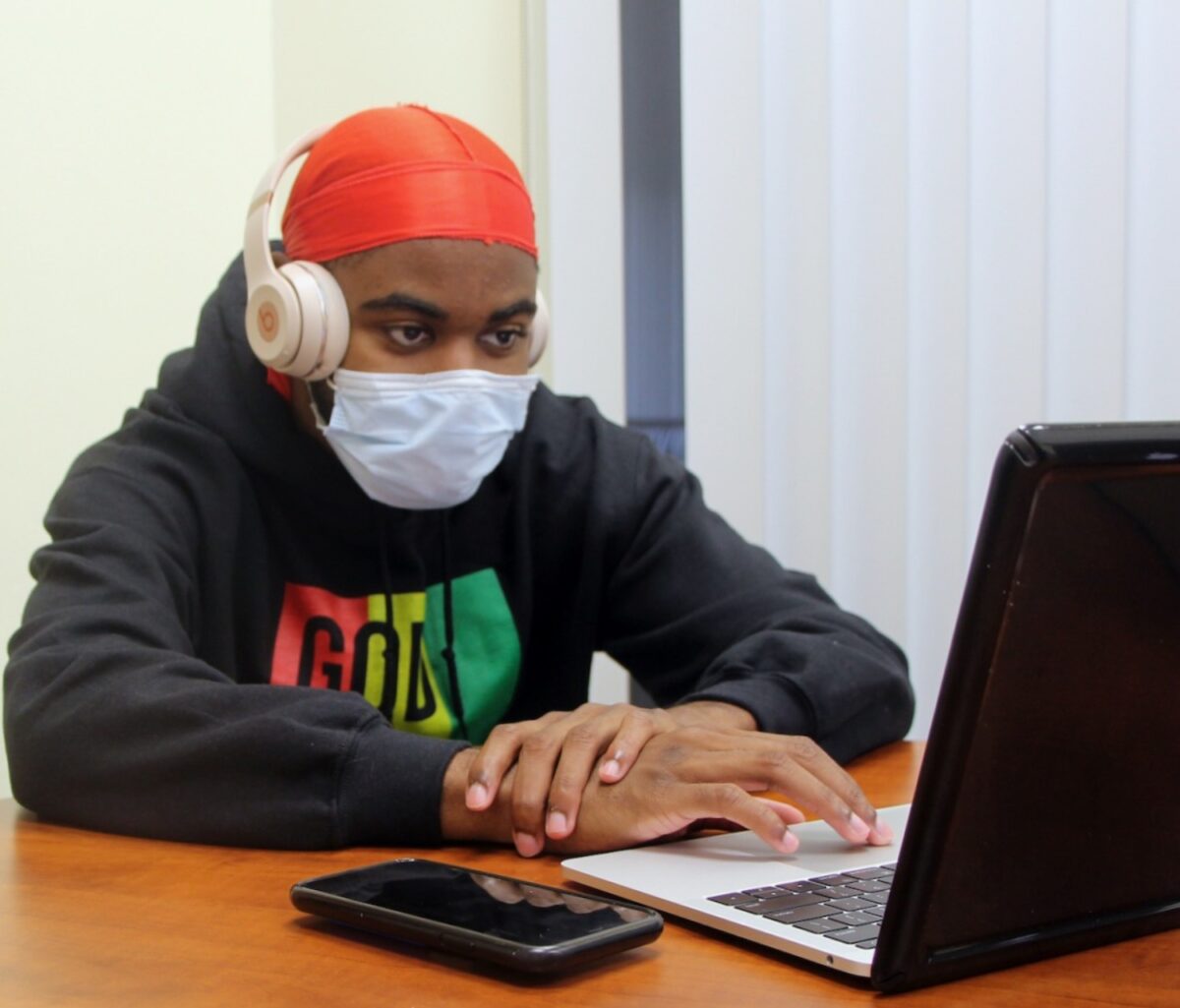Ja'sean Johnson-Henry, a senior marketing major, sits with his headphones on in the multicultural suite, during a tough semester. "Music is my go to outlet for my emotions," Johnson-Henry said. "During the pandemic, quarantine specifically, if I didn't have any songs to listen to, I don't know what I would do. Anytime I was feeling down and I listened to one of my playlists, my day would just be a little bit better. All the new music that has come out this year has also really helped me get through these challenging times." (Photo by Marianna Rappa)