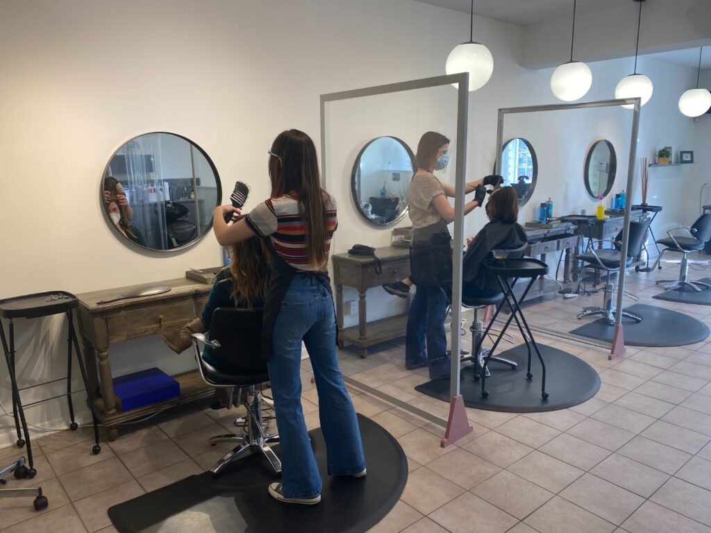 Inside Small Talk Salon where barriers were installed in between chairs in the salon. Photo Credit: Matthew Bruin