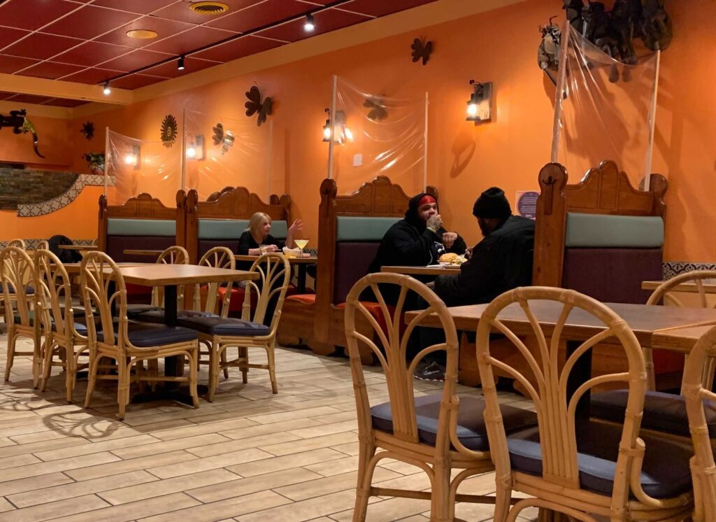 Customer seating with protective shields in between the tables at Ixtapa. Photo: Jensen Coppa