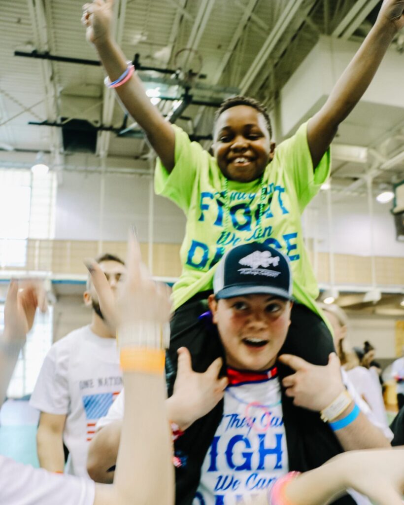 Quinnipiac students and a kid participating in QTHON are dancing during the event in 2019. Photo from QTHON Instagram. Posted Feb. 26, 2020.