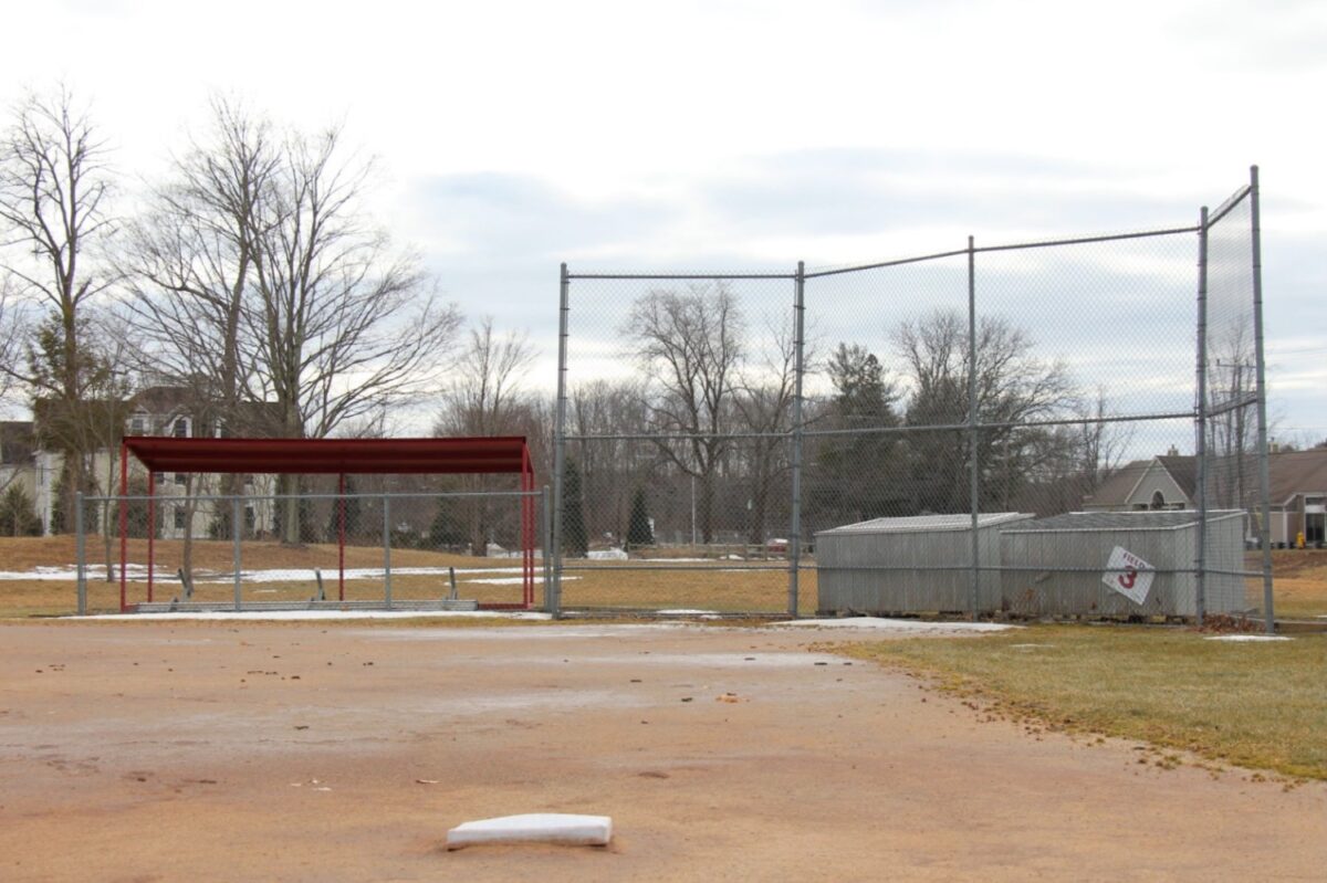 The youth recreation field at Bartlem Park in Cheshire remains untouched, its dugout benches overturned. Photo Credit: Lo Yarnall