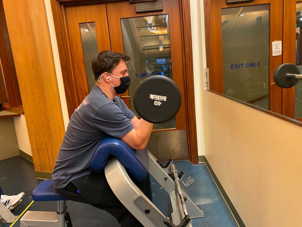 Sean Dalton working out at the gym to help keep in shape after struggling with weight maintenance since high school. Photo Credit: Samantha McCleery