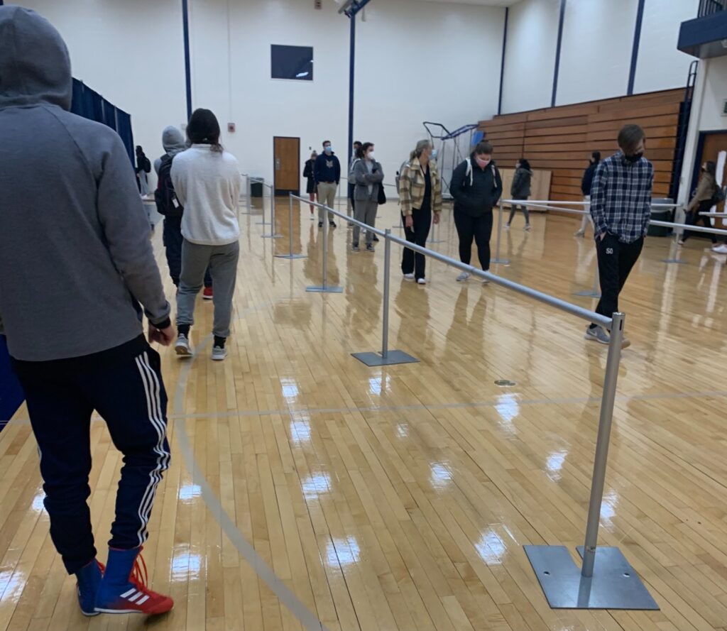 Quinnipiac students await their mandatory weekly COVID test at Burt Kahn Gymnasium: Original Photo by Ben Diiorio