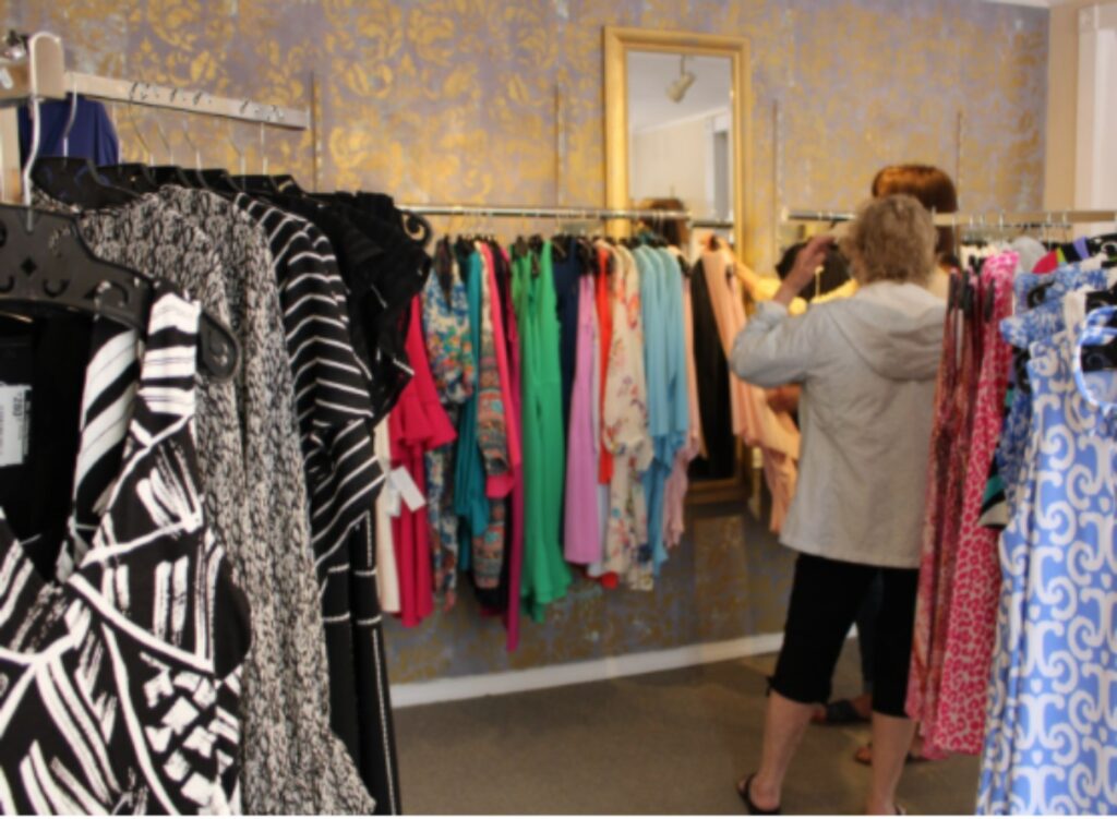 Employee of Flirt helping a customer in need of some comfortable summer dresses as the warmer weather comes around.