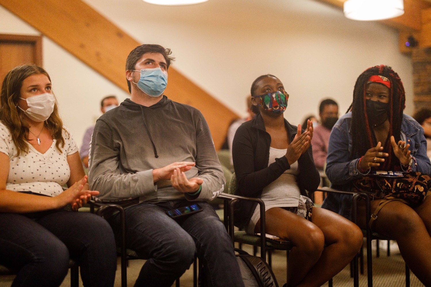 Jack Weitsen (center left) and Owenea Roberts (center right) sit with friends at the Bobcat Culture and Identity Open Mic Night just a few nights after accepting their new roles on campus. (Contributed by Dan Passapera)