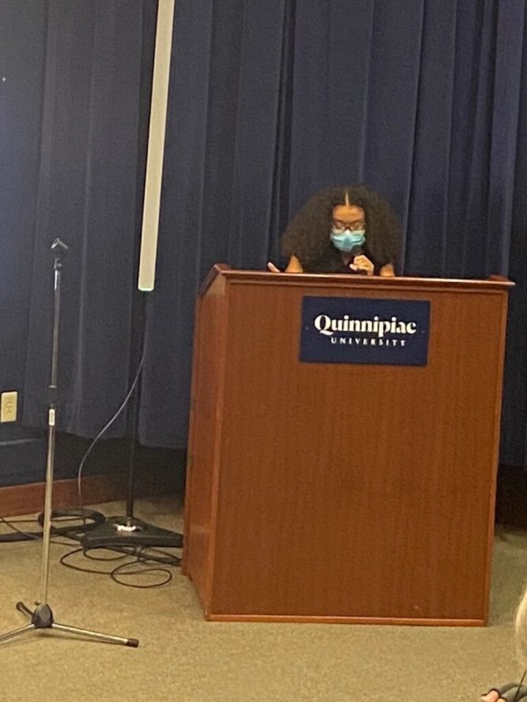 Olivia Barrios-Johnson reads an excerpt from an essay she wrote last semester, expressing the importance of celebrating Black women's hair.  Photo courtesy Ryan Coope.