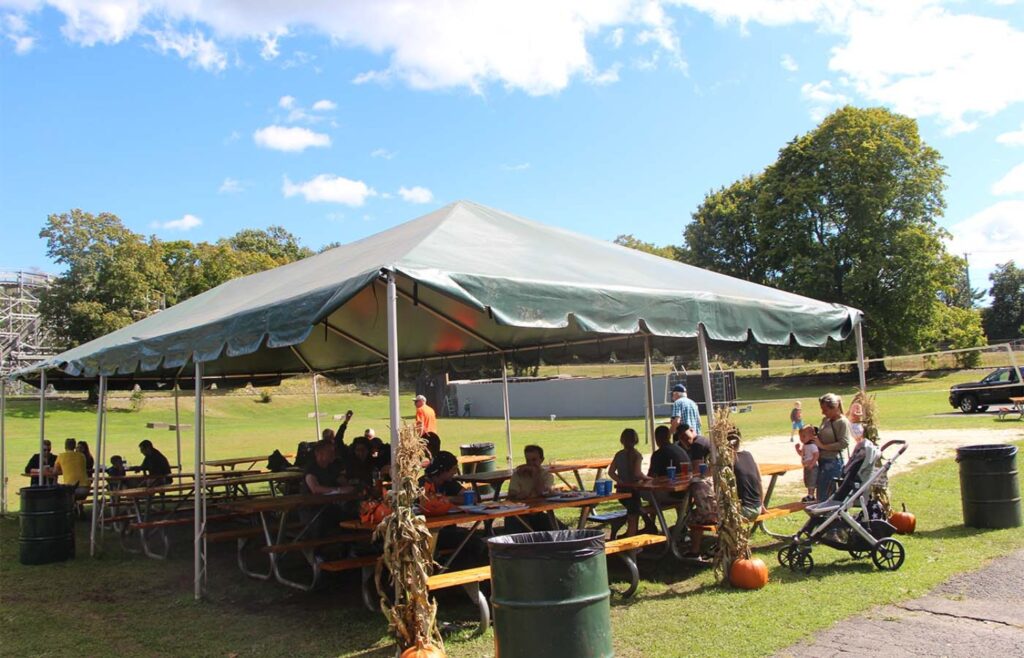 People eating and talking while sitting outside of the pavilion. Photo by Will Knox