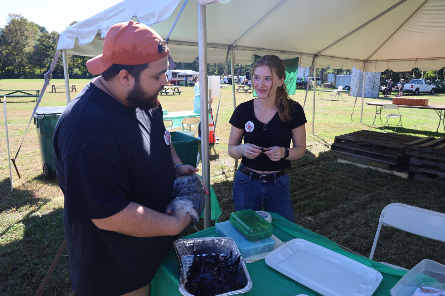 Joshua Garcia (left) and Emma Atskinson (right) volunteering at the nature craft station for kids. (Photo by Samantha Simon)