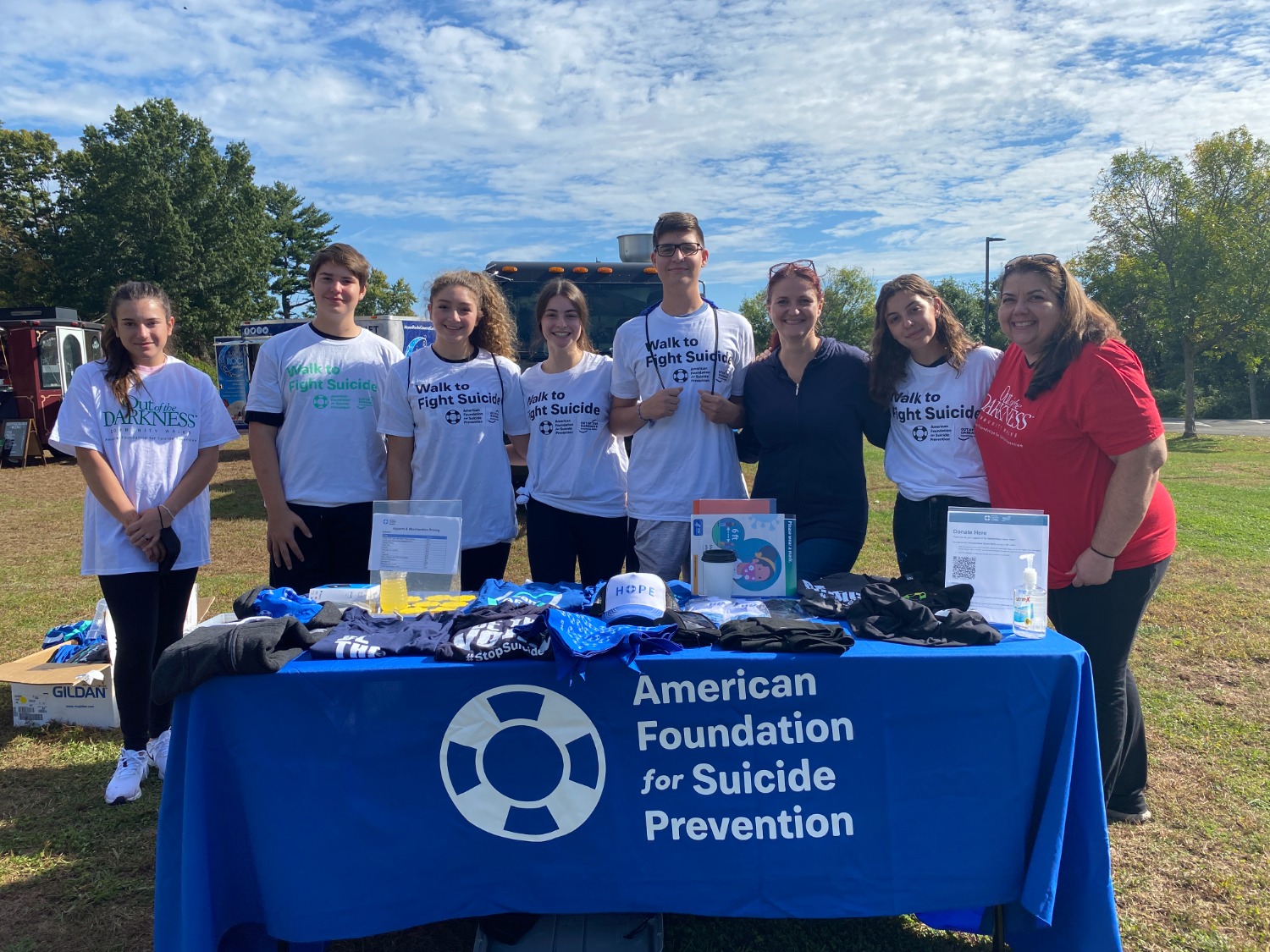 AFSP volunteers circle around a merchandise table at the Out Of The Darkness Walk in Hamden. Photo courtesy of Dalton Rice