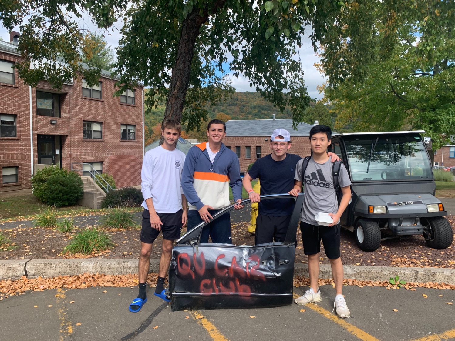 Students get to claim bits and pieces of the wrecker car - pictured from left to right: Matthew Mazzarelli, Gabe quiroz, Sebastian Leon, and John Chen - Photo by Alena DeLuise