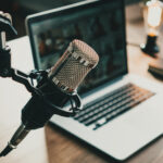 Home studio podcast interior. Microphone, laptop and on air lamp on the table, close-up. Photo by Alex from the Rock, Adobe Stock